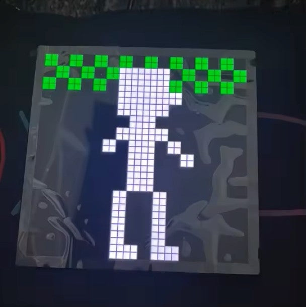 Pixel art LED display showing a white figure with green top, customizable for desk setups